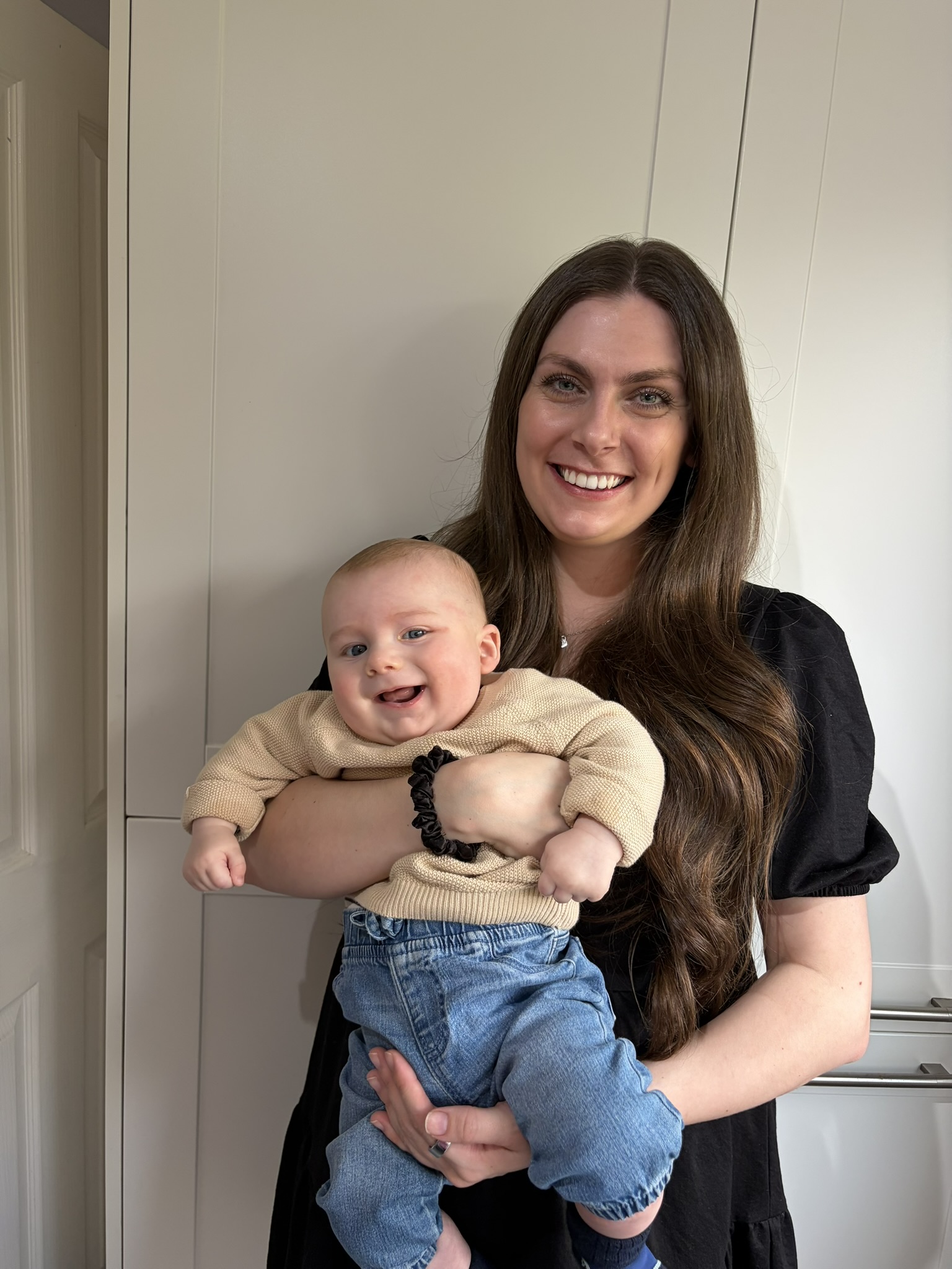Opi holding a smiling baby